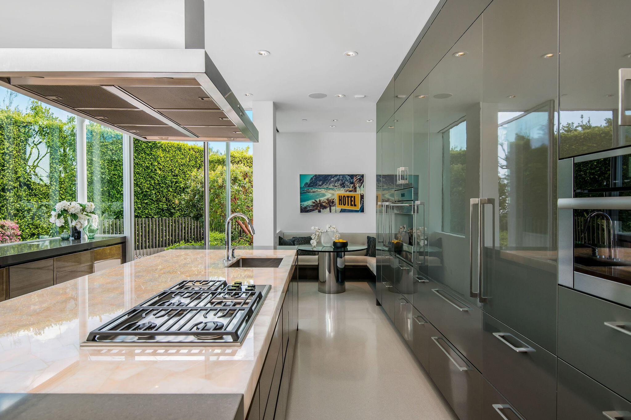 1288 Angelo Drive Beverly Hills, CA 90210 - Photo 13 of 33 a kitchen with stainless steel appliances granite countertop a stove and a view of living room