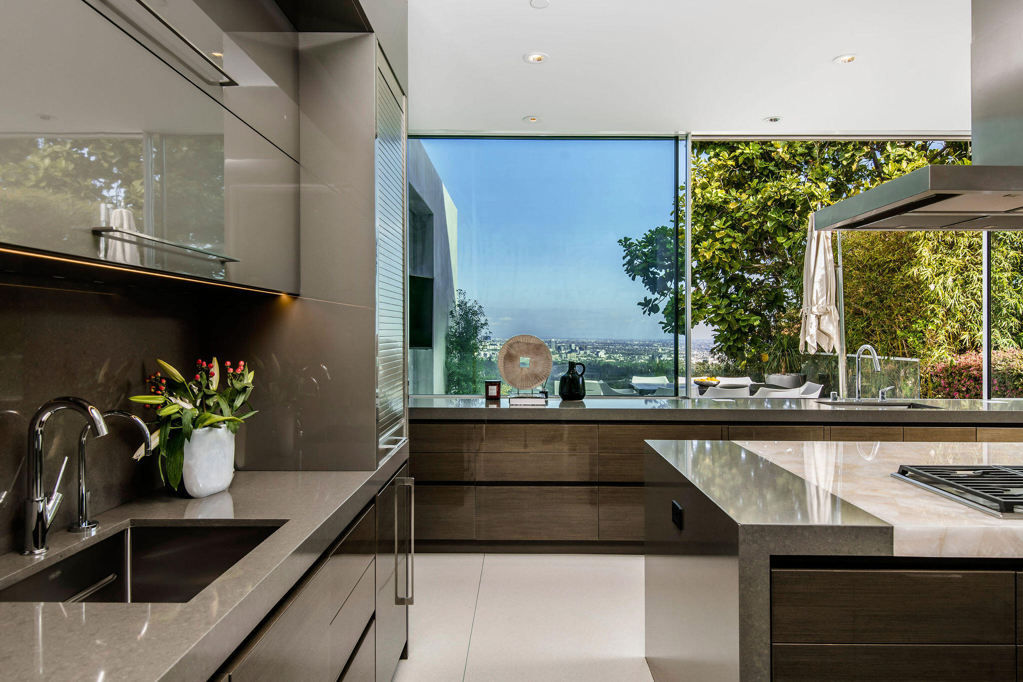 1288 Angelo Drive Beverly Hills, CA 90210 - Photo 14 of 33 a table with a potted plant on it and a wooden floor