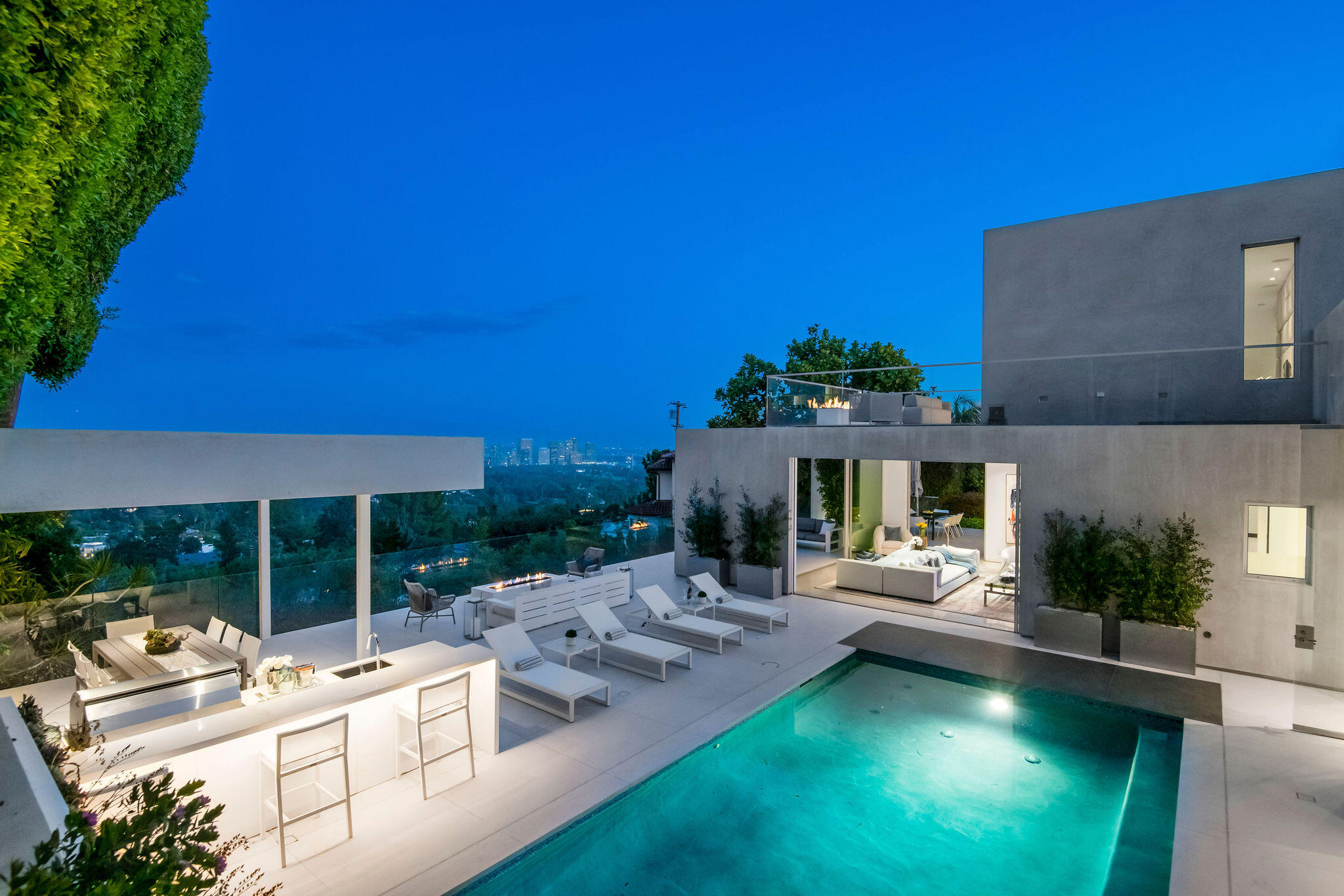 1288 Angelo Drive Beverly Hills, CA 90210 - Photo 32 of 33 a view of a house with backyard porch and furniture
