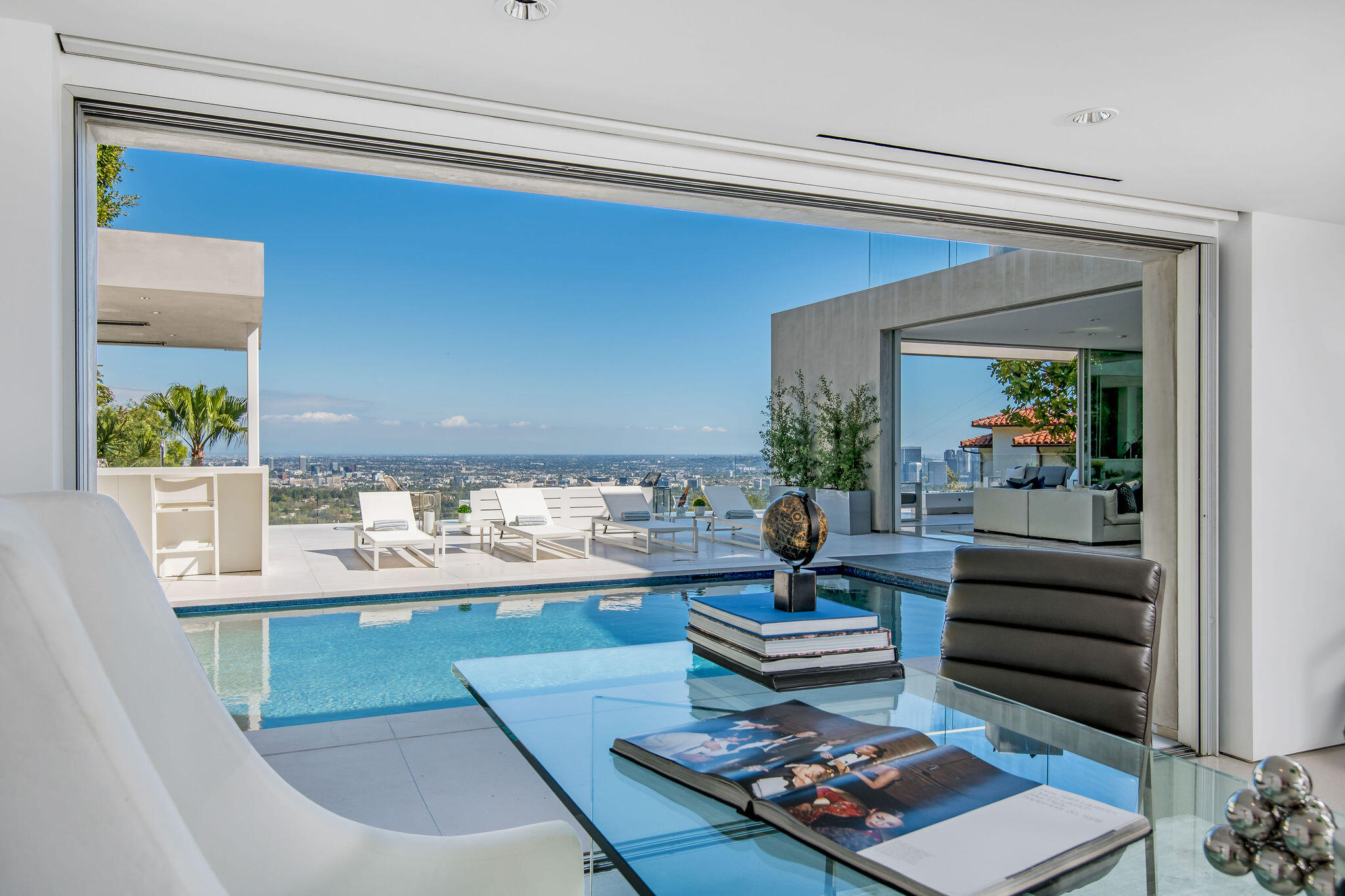 1288 Angelo Drive Beverly Hills, CA 90210 - Photo 10 of 33 a living room with a couch and a potted plant on coffee table