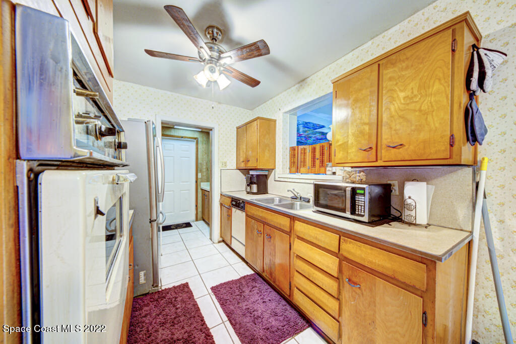 1210 Princeton Road Cocoa, FL 32922 - Photo 11 of 37 a kitchen with stainless steel appliances granite countertop a refrigerator a stove and a sink