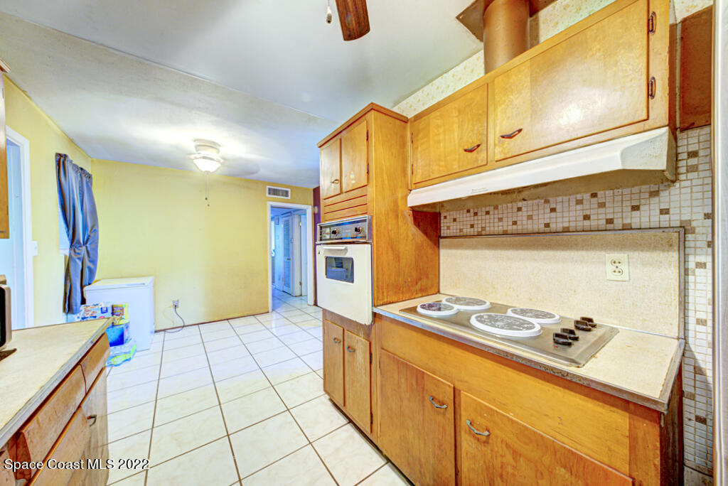 1210 Princeton Road Cocoa, FL 32922 - Photo 12 of 37 a kitchen with stainless steel appliances a cabinets and a stove top oven