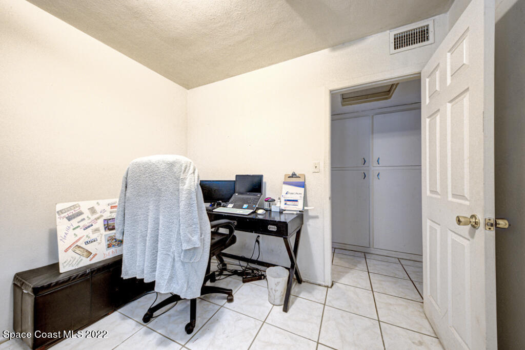 1210 Princeton Road Cocoa, FL 32922 - Photo 20 of 37 a view of a workspace with furniture and a window