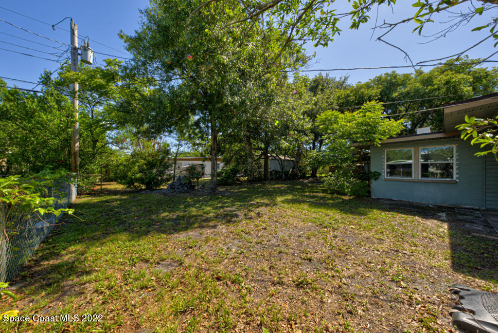 1210 Princeton Road Cocoa, FL 32922 - Photo 37 of 37 a backyard of a house with plants and large trees