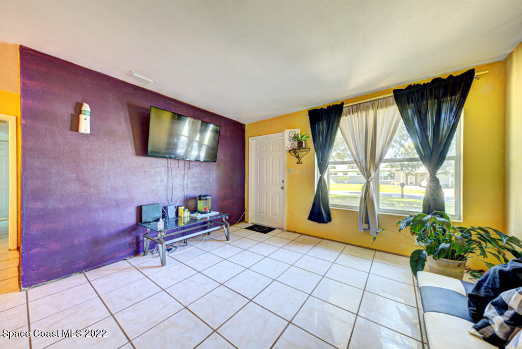 1210 Princeton Road Cocoa, FL 32922 - Photo 6 of 37 a living room with furniture and a flat screen tv