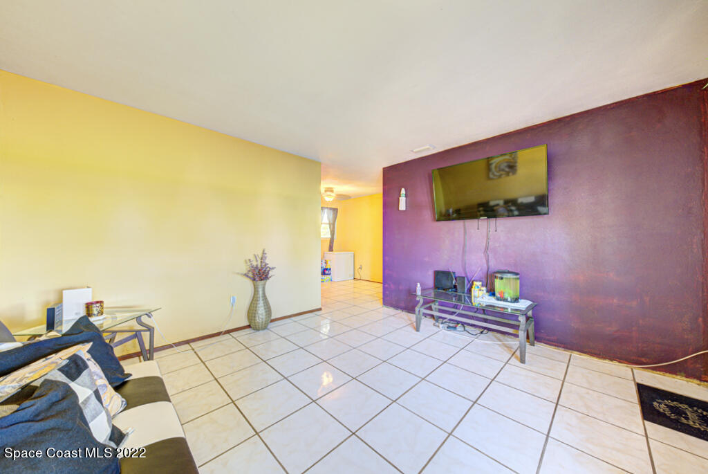 1210 Princeton Road Cocoa, FL 32922 - Photo 7 of 37 a bedroom with furniture and a flat screen tv