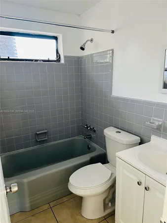 a white toilet sitting next to a bath tub