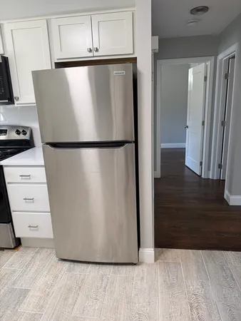 a white refrigerator freezer sitting in a kitchen