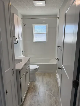 a bathroom with a sink a toilet a shower and a mirror