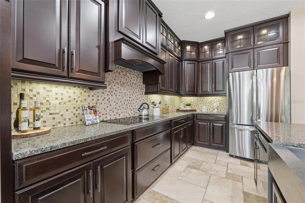 4527 Scarlet Loop Wesley Chapel, FL 33544 - Photo 11 of 33 a kitchen with stainless steel appliances granite countertop a sink stove and refrigerator