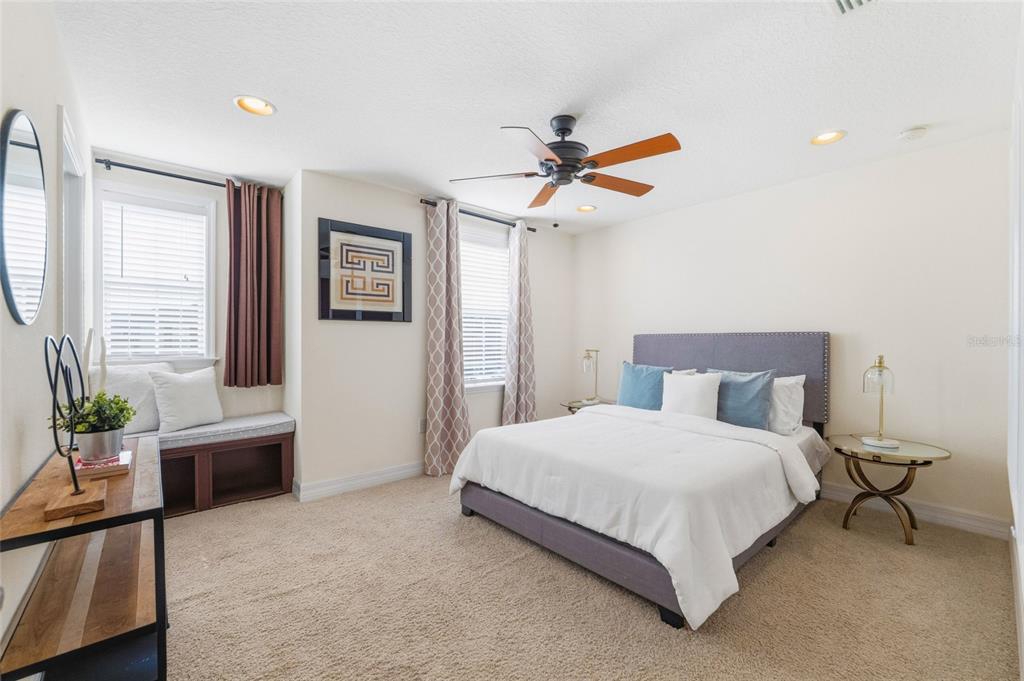 4527 Scarlet Loop Wesley Chapel, FL 33544 - Photo 13 of 33 a bedroom with a bed dresser and a window