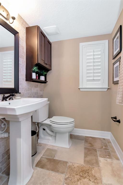4527 Scarlet Loop Wesley Chapel, FL 33544 - Photo 18 of 33 a bathroom with a sink a toilet and mirror