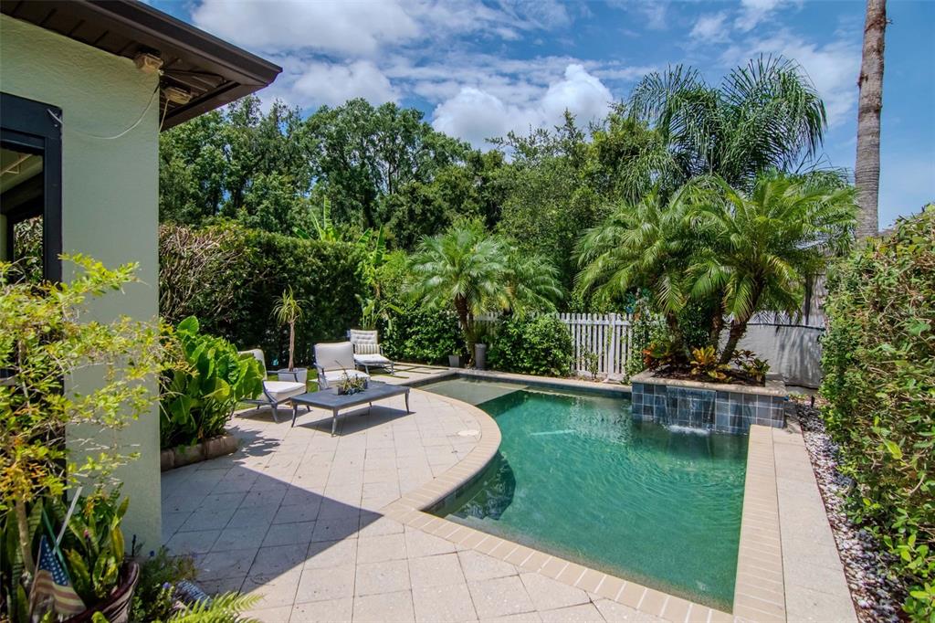 4527 Scarlet Loop Wesley Chapel, FL 33544 - Photo 23 of 33 a view of a backyard with sitting area