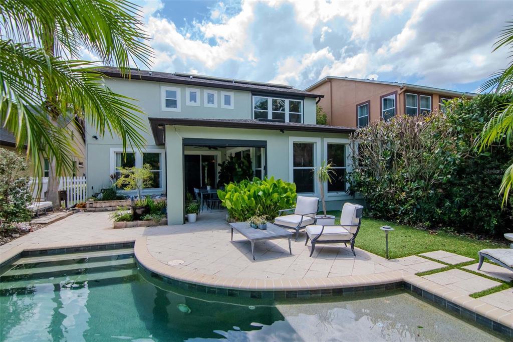 4527 Scarlet Loop Wesley Chapel, FL 33544 - Photo 25 of 33 a view of a house with backyard sitting area and furniture