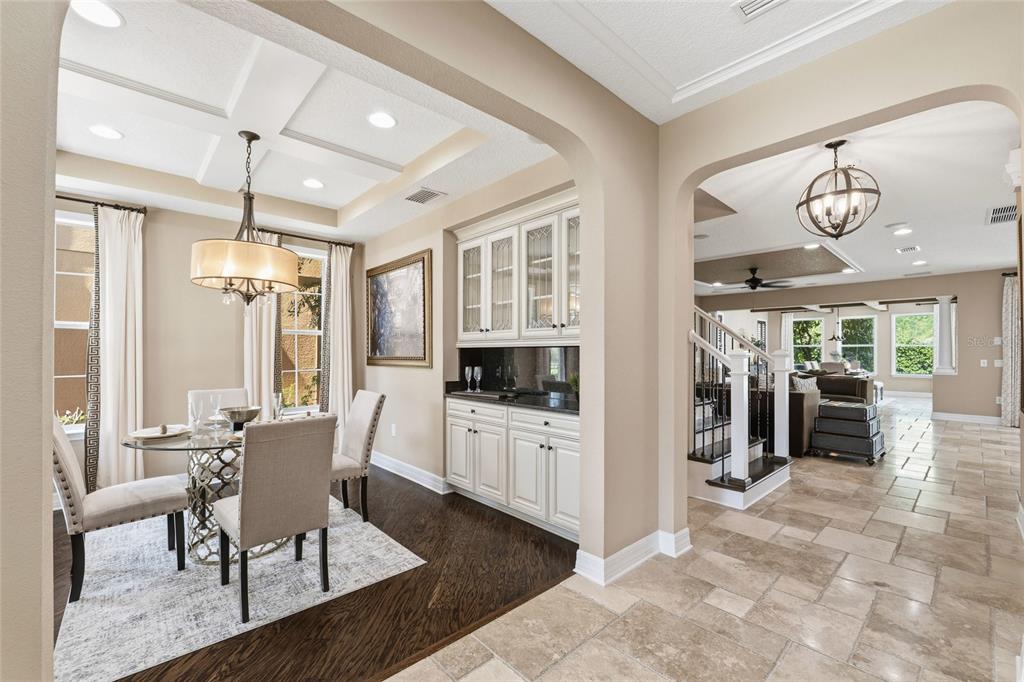 4527 Scarlet Loop Wesley Chapel, FL 33544 - Photo 3 of 33 a dining room with wooden floor and furniture