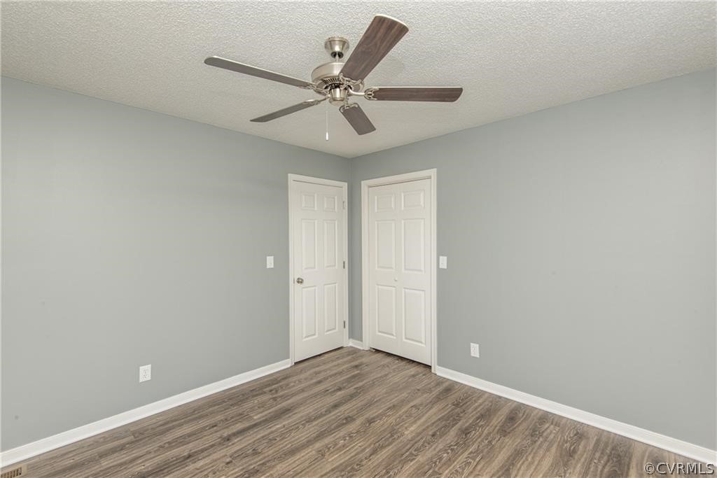17550 Interstate Lane Dewitt, VA 23840 - Photo 18 of 29 a view of an empty room with wooden floor and a ceiling fan