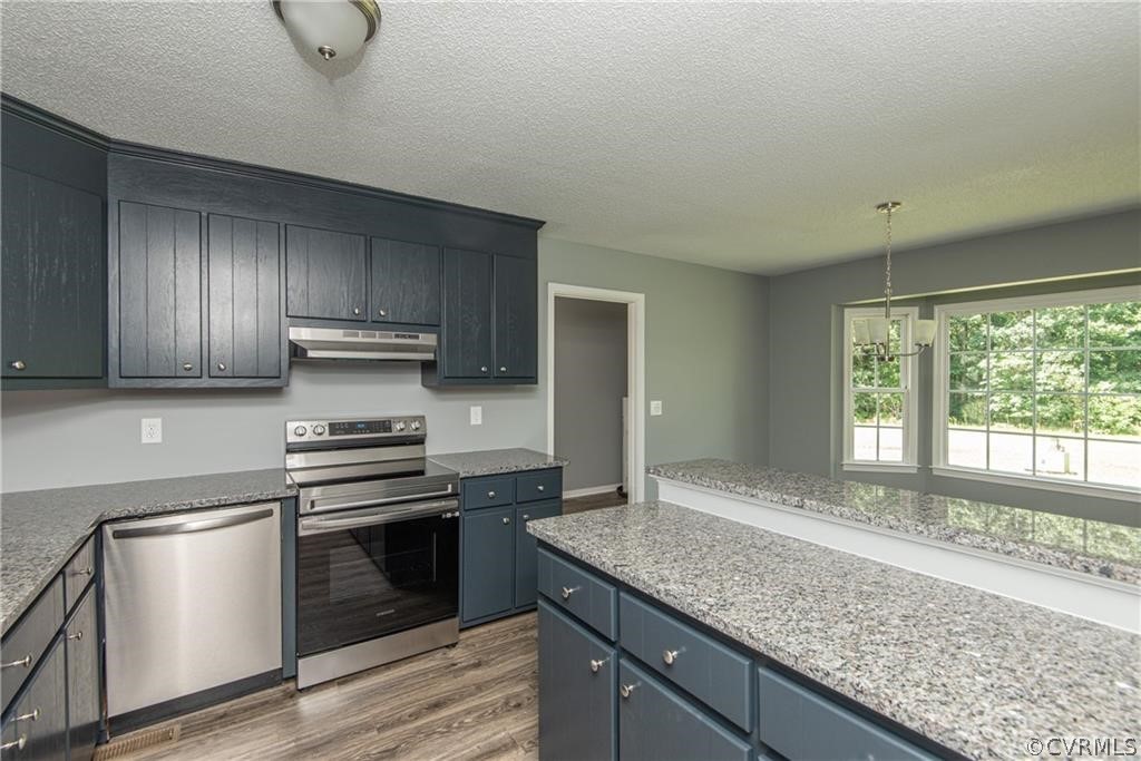 17550 Interstate Lane Dewitt, VA 23840 - Photo 9 of 29 a kitchen with granite countertop stainless steel appliances a sink stove and refrigerator