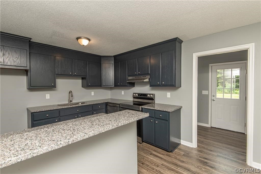 17550 Interstate Lane Dewitt, VA 23840 - Photo 10 of 29 a kitchen with granite countertop wooden cabinets a stove top oven a sink and dishwasher