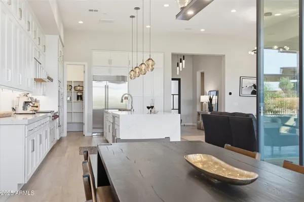 a kitchen with stainless steel appliances granite countertop a refrigerator a sink and a stove