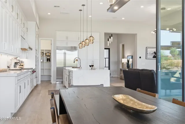 a kitchen with stainless steel appliances granite countertop a refrigerator a sink and a stove