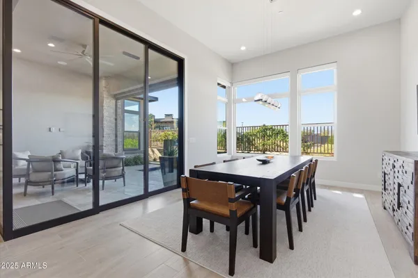 a view of a dining room and livingroom with furniture wooden floor and a rug