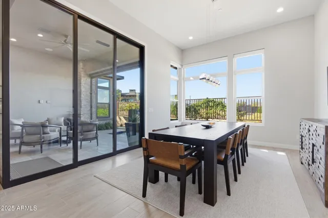 a view of a dining room and livingroom with furniture wooden floor and a rug