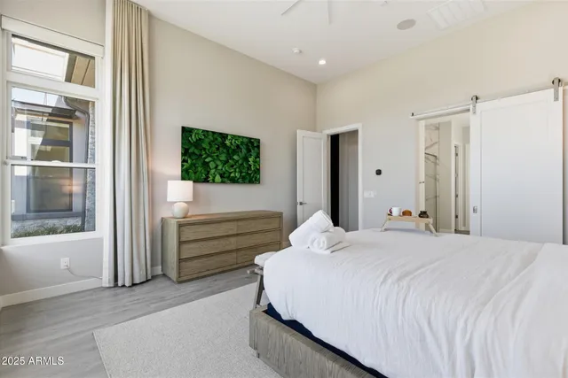 a bedroom with a bed and a flat screen tv