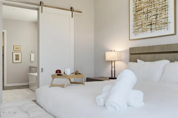 a bedroom with a bed and a night stand