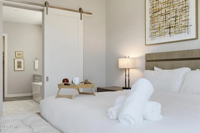 a bedroom with a bed and a night stand