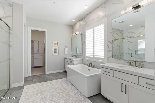 a bathroom with a sink mirror and a bathtub