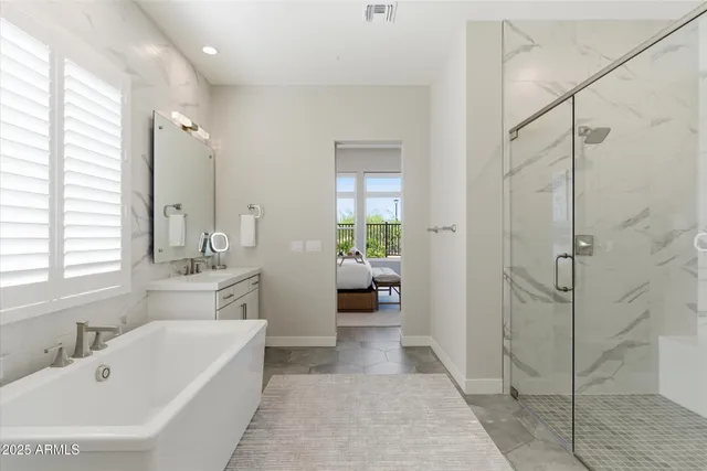 a en suite spacious bathroom with a tub shower and window
