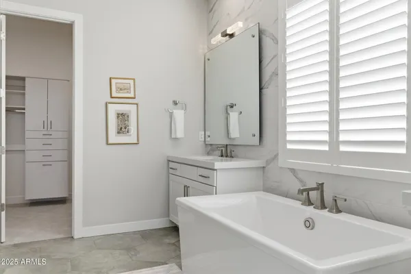 a white bath tub sitting next to a white sink