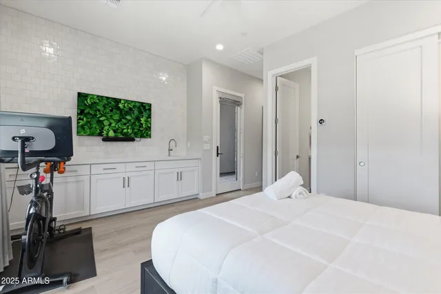 a bedroom with a bed and a flat screen tv