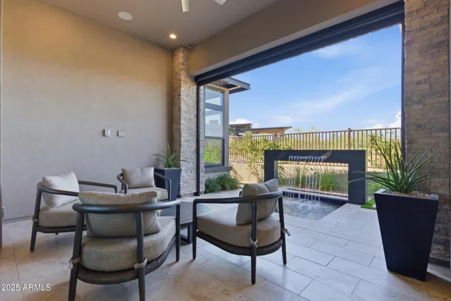 a living room with furniture and a floor to ceiling window
