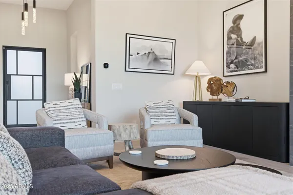 a living room with furniture and wooden floor