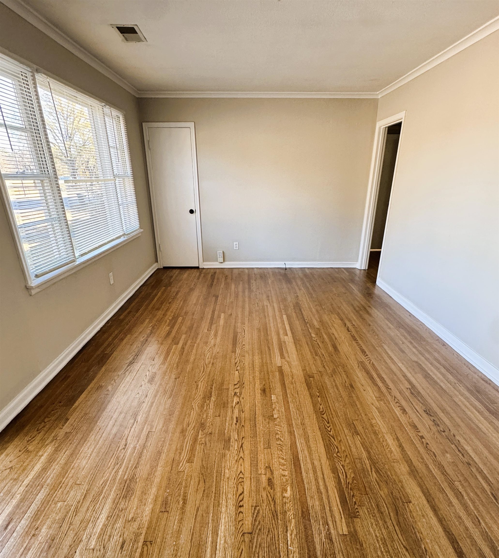 1331 Colonial Road Memphis, TN 38117 - Photo 2 of 18 an empty room with wooden floor and windows