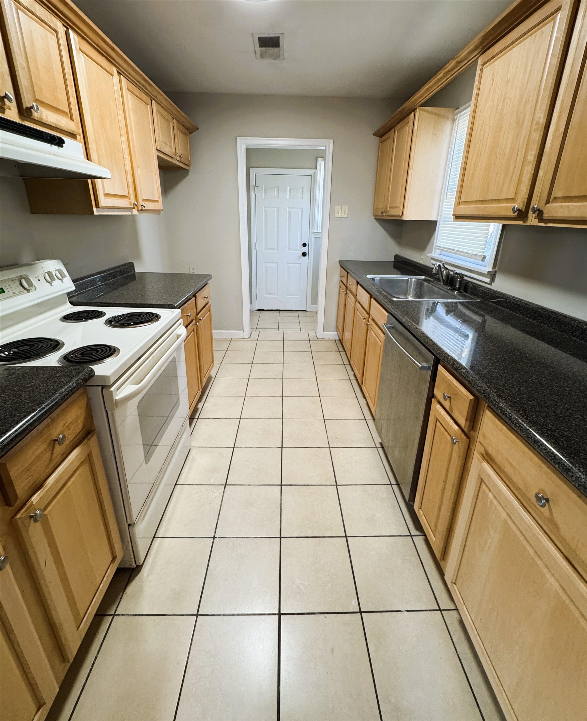 1331 Colonial Road Memphis, TN 38117 - Photo 6 of 18 a kitchen with a stove a sink and a microwave