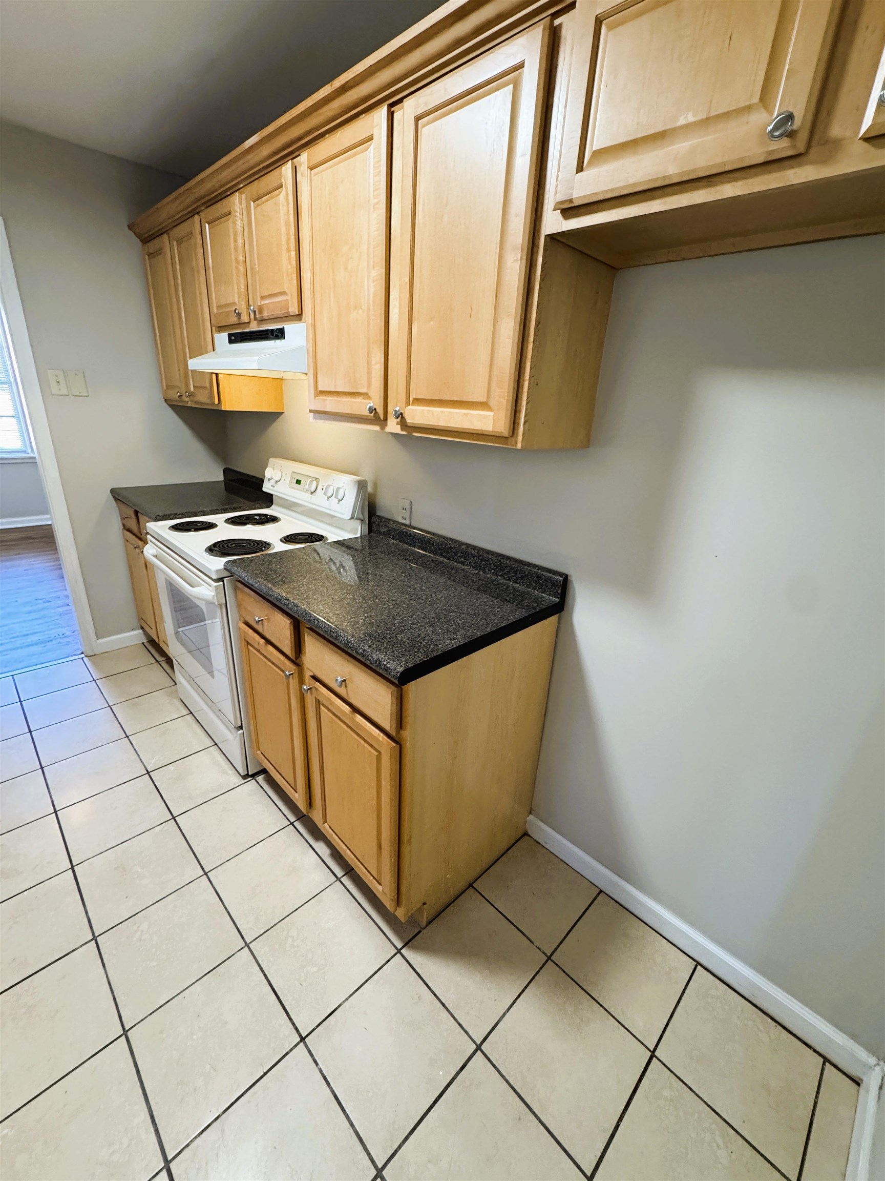 1331 Colonial Road Memphis, TN 38117 - Photo 8 of 18 a kitchen with stainless steel appliances granite countertop a stove a sink and a white cabinets