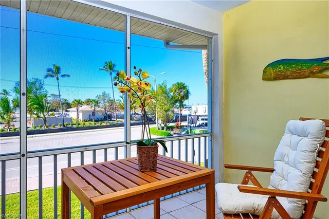 a view of a balcony with wooden chairs