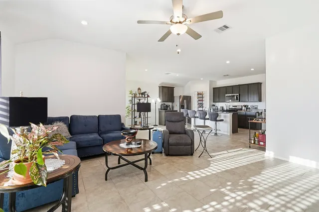 a living room with furniture and kitchen view