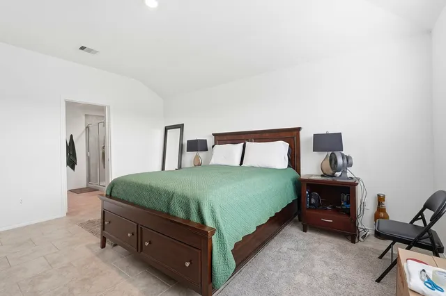 a bedroom with a bed and a table