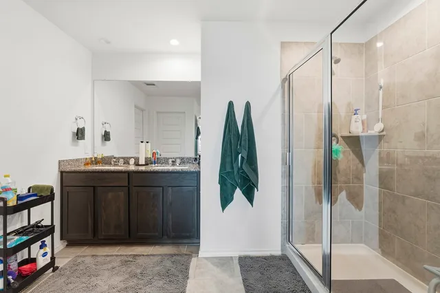 a bathroom with a shower and a sink