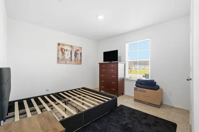 a bedroom with furniture and flat screen tv