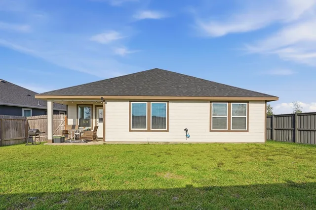 a front view of a house with a garden and yard