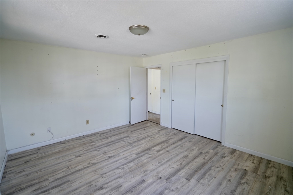 92 Beacon Street, Unit 6 Lawrence, MA 01843 - Photo 11 of 22 a view of an empty room with wooden floor