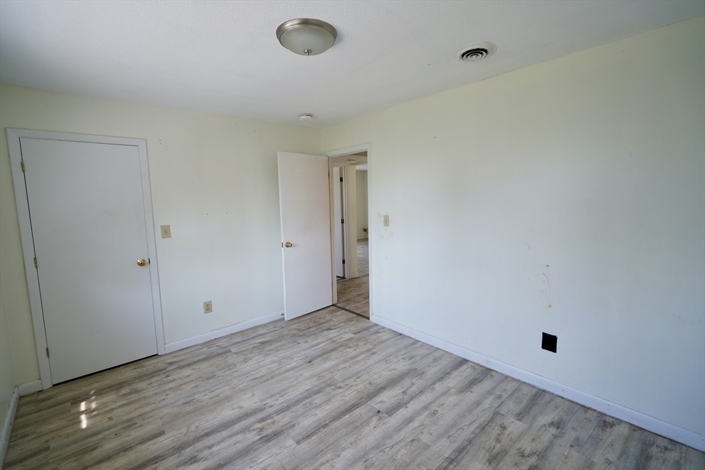 92 Beacon Street, Unit 6 Lawrence, MA 01843 - Photo 13 of 22 a view of an empty room with wooden floor