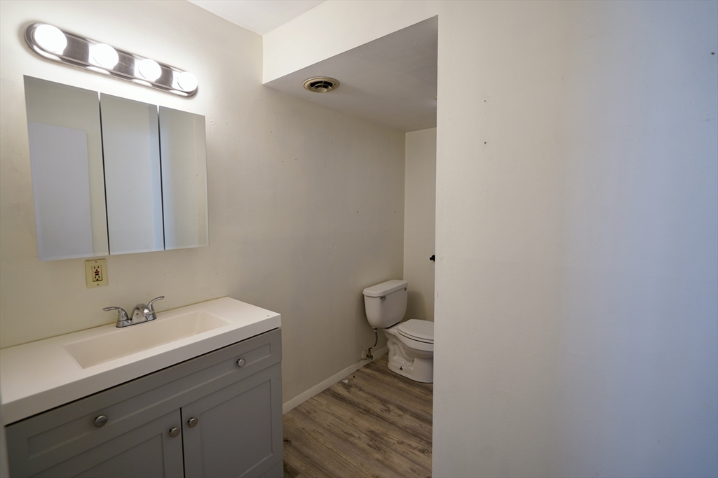 92 Beacon Street, Unit 6 Lawrence, MA 01843 - Photo 14 of 22 a bathroom with a sink toilet and vanity