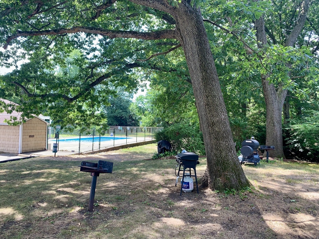 92 Beacon Street, Unit 6 Lawrence, MA 01843 - Photo 21 of 22 a view of a backyard with a table and chairs