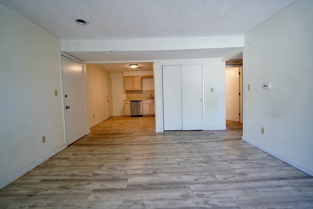 92 Beacon Street, Unit 6 Lawrence, MA 01843 - Photo 5 of 22 a view of empty room with wooden floor