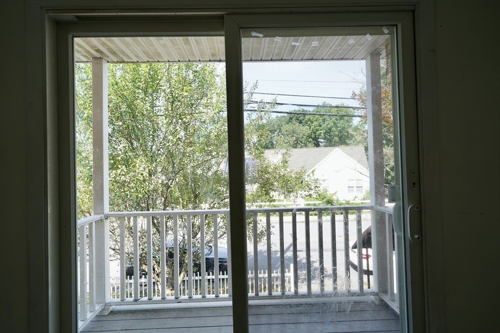92 Beacon Street, Unit 6 Lawrence, MA 01843 - Photo 7 of 22 a view of a wooden deck and a yard